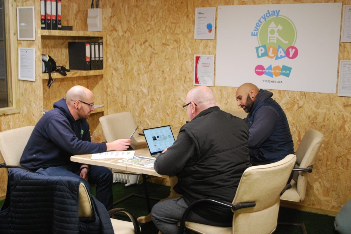 Playground workshop meeting with three people discussing playground equipment in Kent
